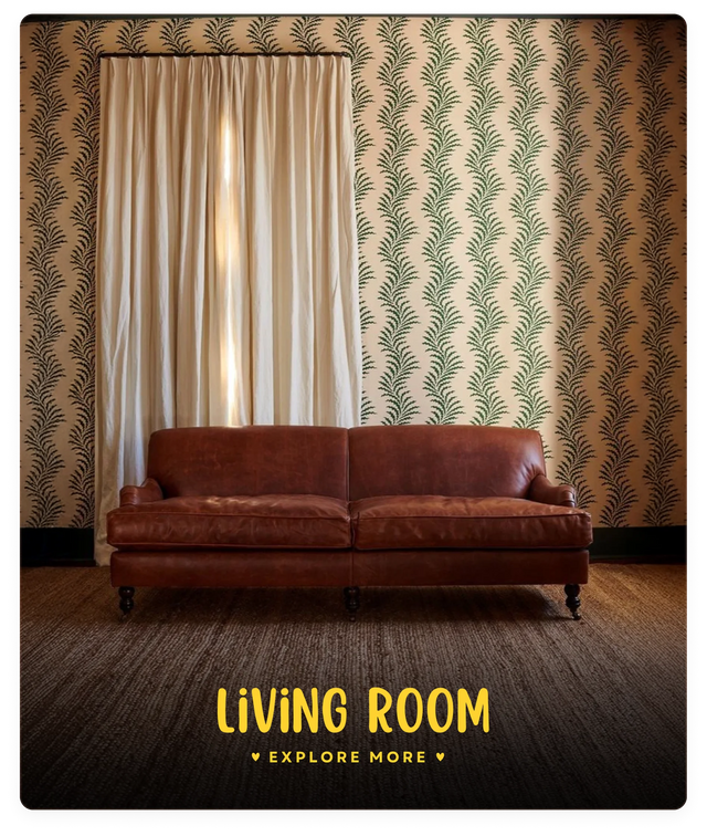 Brown leather sofa in a living room with patterned wallpaper and curtains.