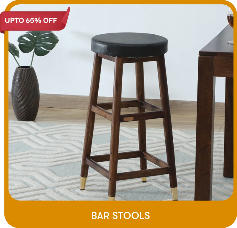 Wooden bar stool with black seat in a room