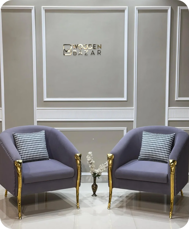 Two purple armchairs with gold legs in a room