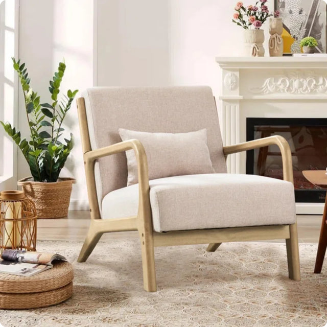 Beige armchair in a living room with a fireplace